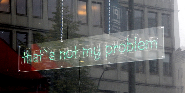 Berlin Greenpeace sign in office window - That's not my problem